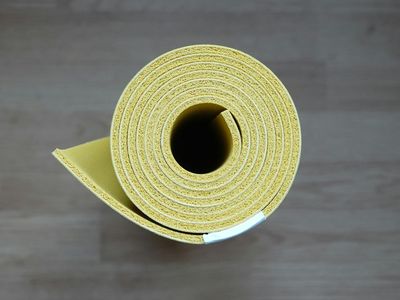 Yoga mat and accessories on dark wooden floor